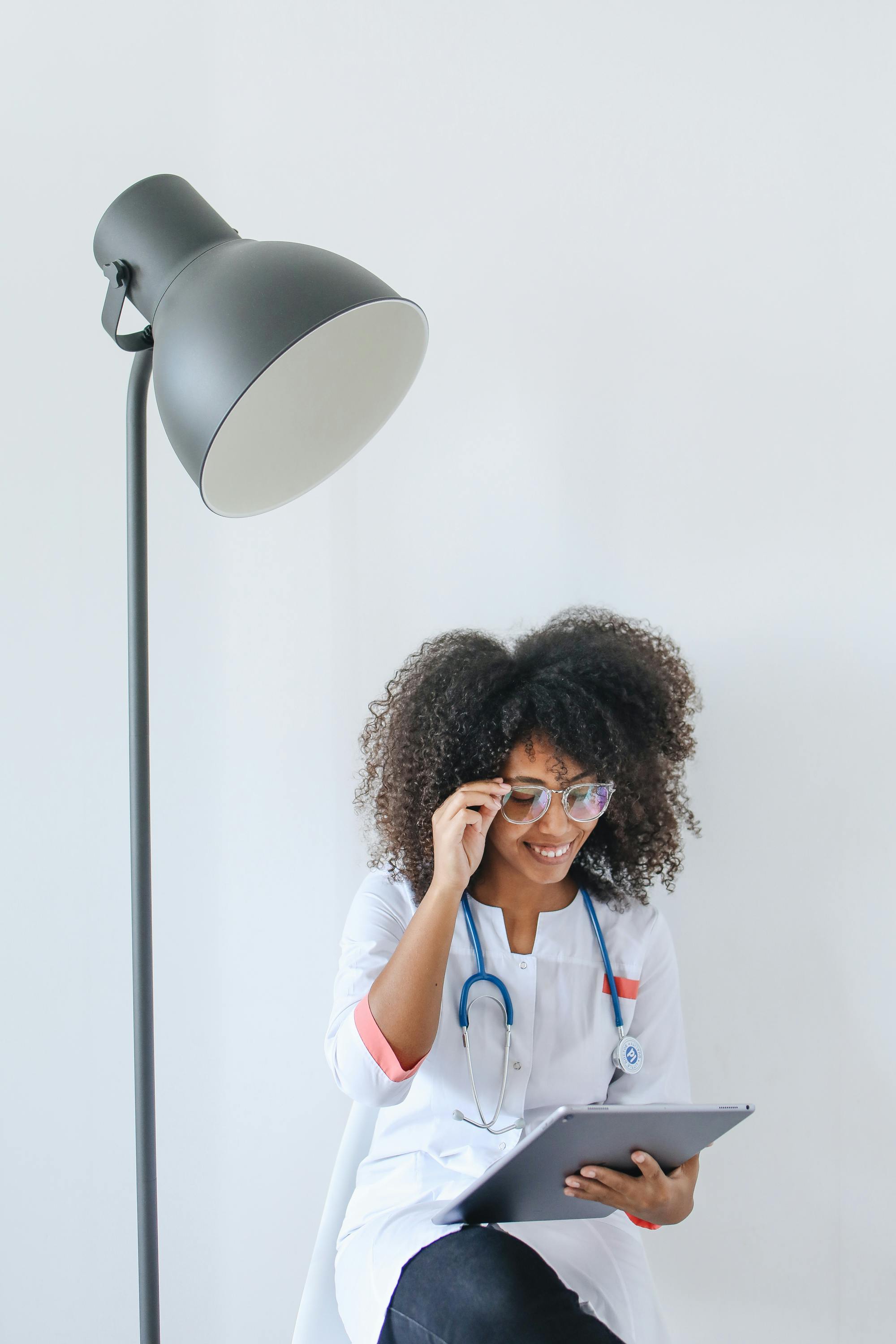 African clinician reviewing patient records on a tablet